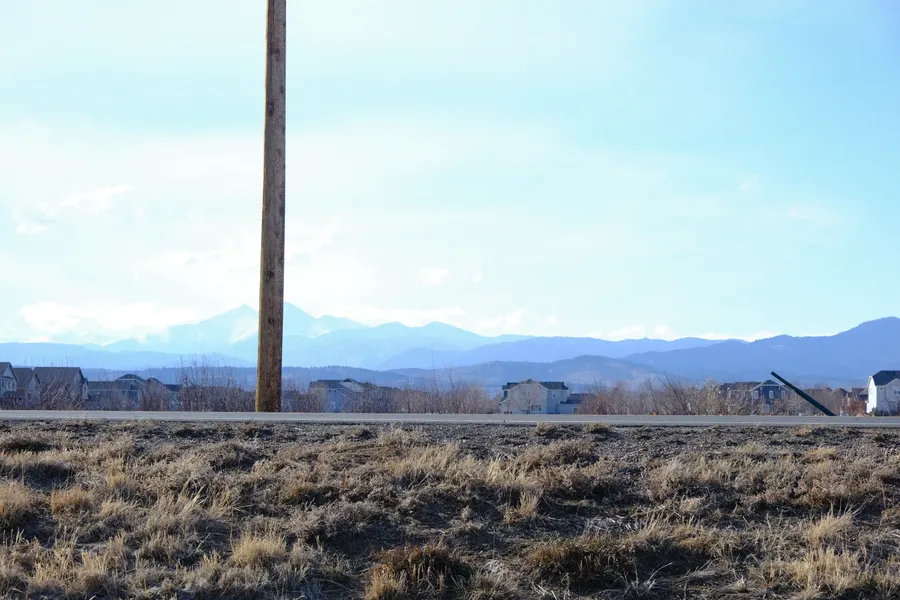 a telephone pole with mountains on horizon